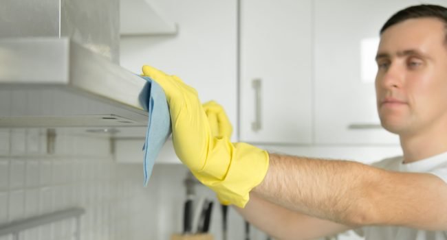 closeup-male-hands-rubber-gloves-cleaning-extractor-hood-scaled.jpg