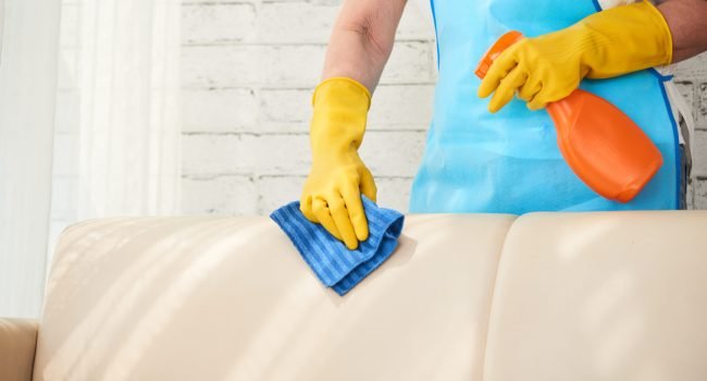 mid-section-unrecognizable-housekeeper-wiping-leather-sofa-with-leather-polish-spray1-scaled.jpg